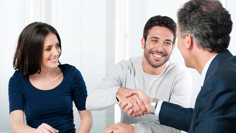 couple shaking heads with salesman Clint Newell Chevrolet in Roseburg OR